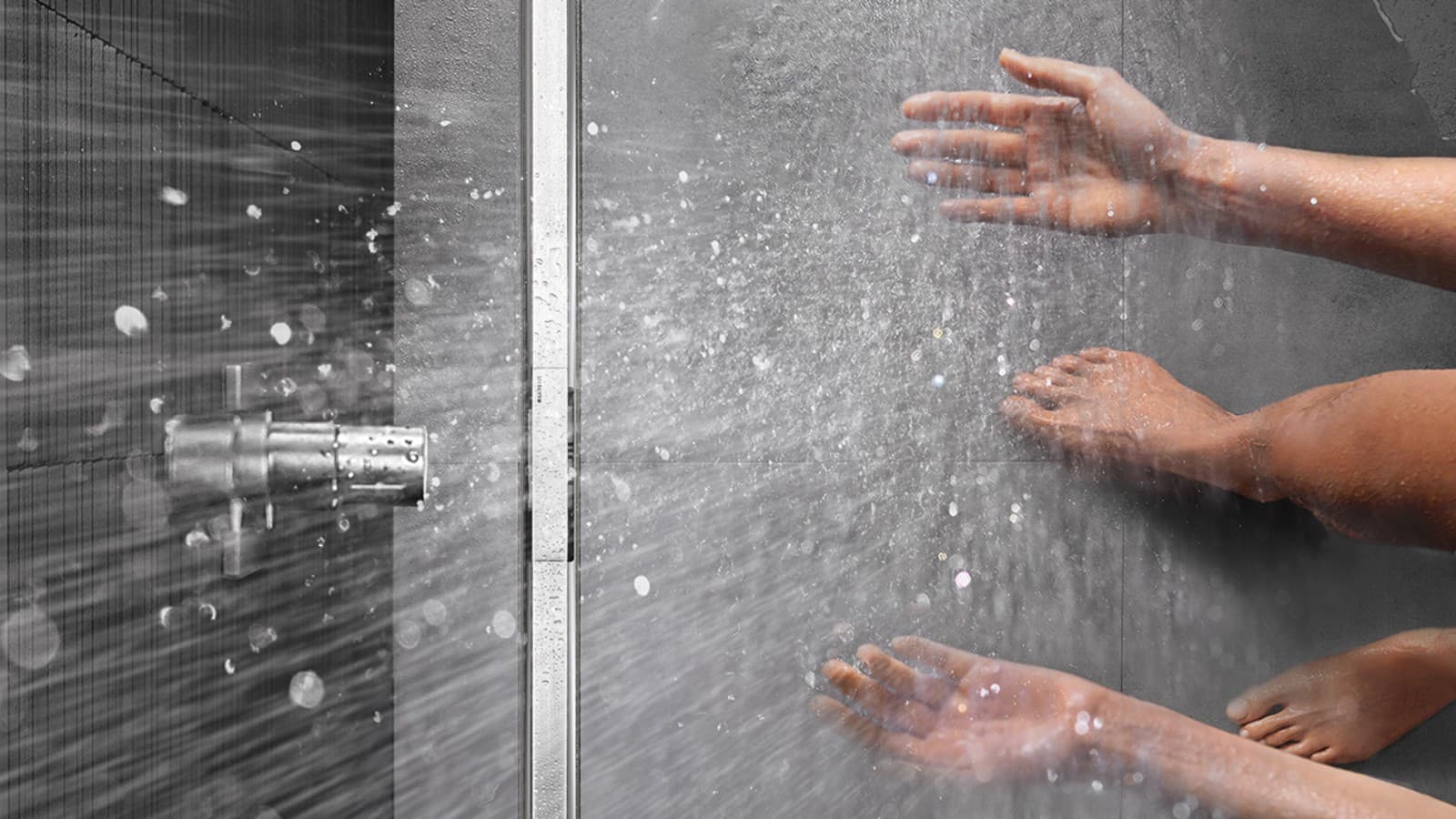 Person showering in a floor-even shower with Geberit CleanLine shower channel Person showering in a floor-even shower with Geberit CleanLine shower channel