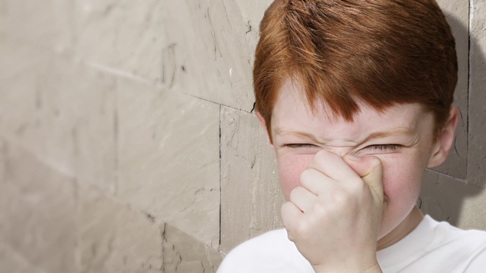 Boy holds his nose Boy holds his nose